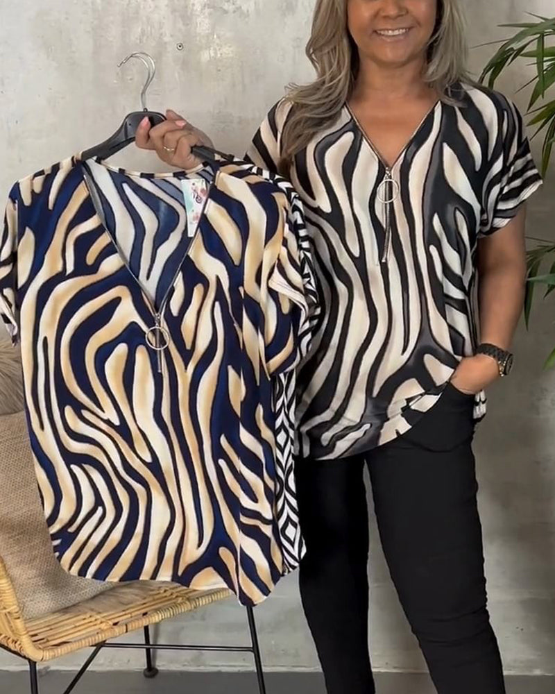 Stilfuld bluse med zebraprint og lynlås