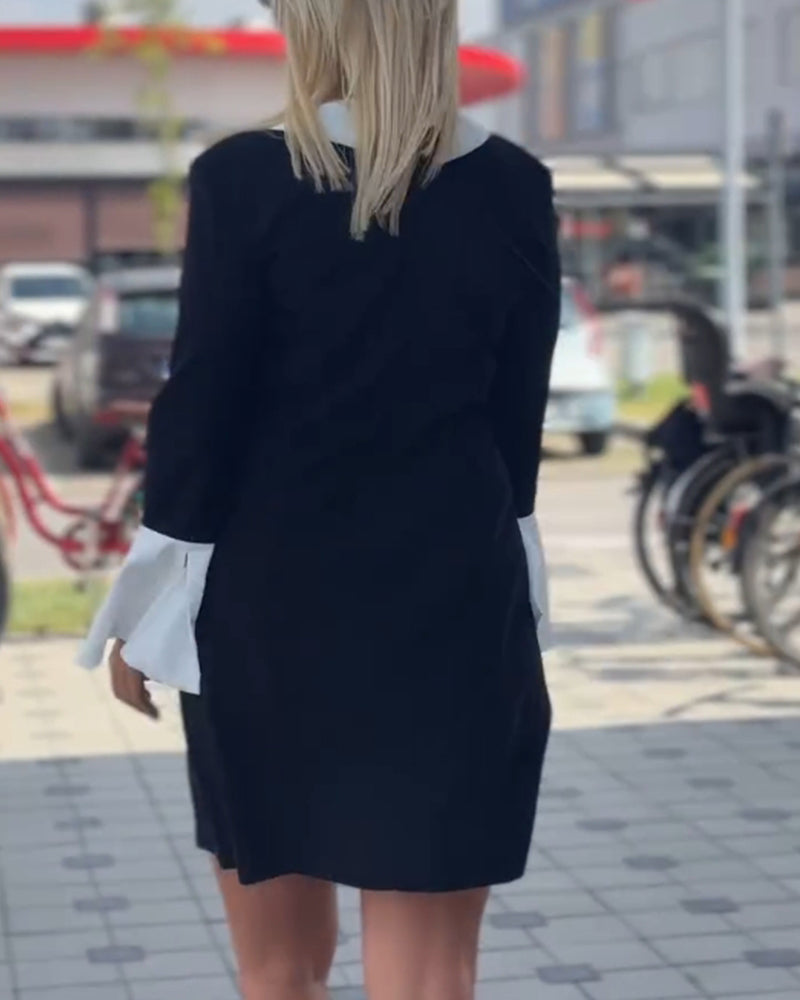 Elegant kjole med klokkeærmer og falsk lagdeling