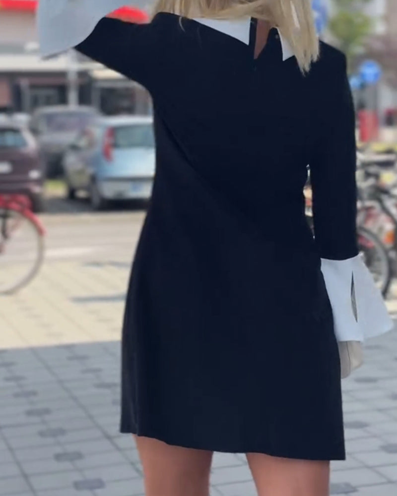 Elegant kjole med klokkeærmer og falsk lagdeling