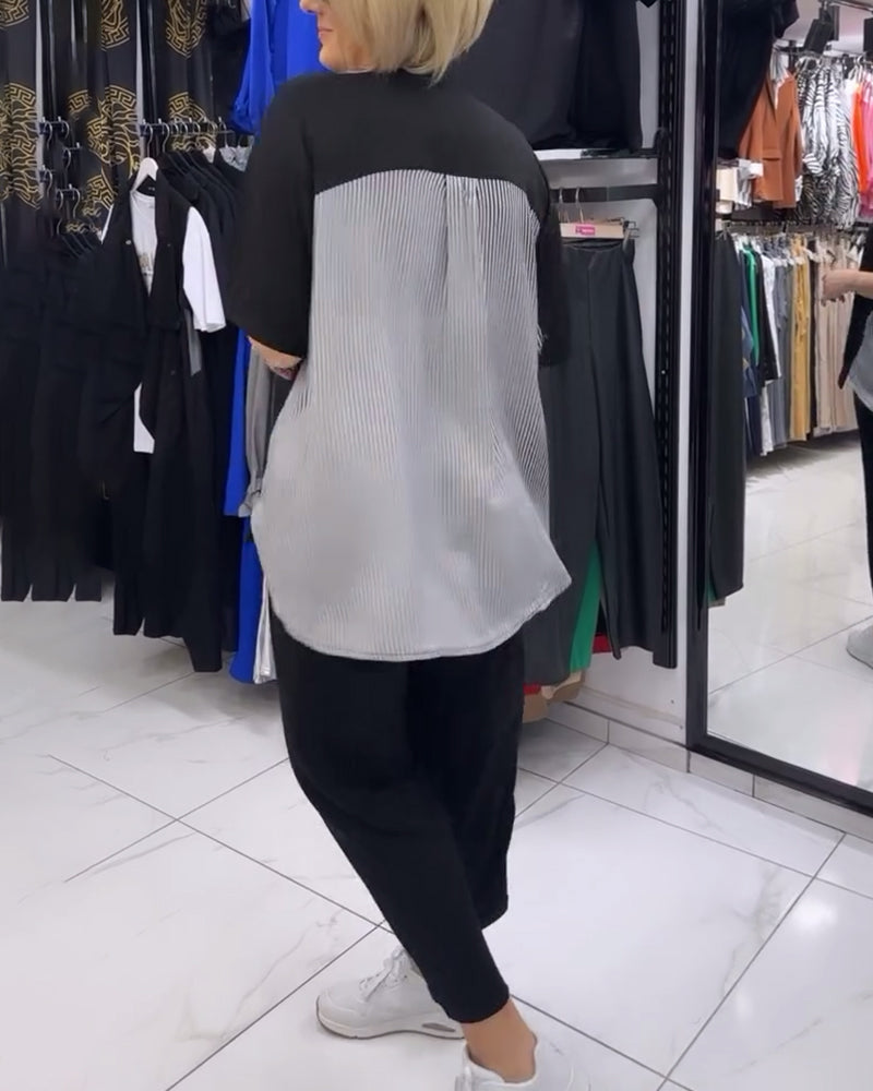 Afslappet sort bluse med nålestribet ryg